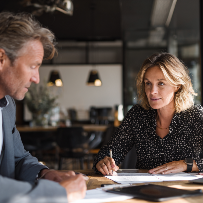 u3166295398_Two_people_in_discussion_during_a_meeting_with_a__9ce4bb08-634c-43d3-8e32-2d769120f8c8_0